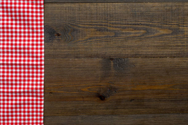 istock Red picnic cloth on wooden table, top view 1317657289
