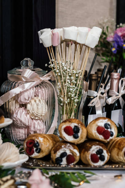 istock marshmallow on sticks and rolls with cream on the festive table 1317657687