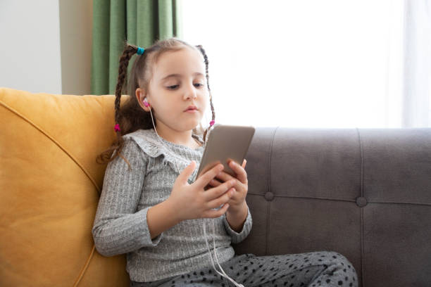 istock little girl using smart phone 1317662340