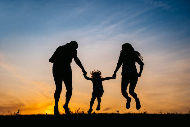 istock Family jump at sunset 1317667318