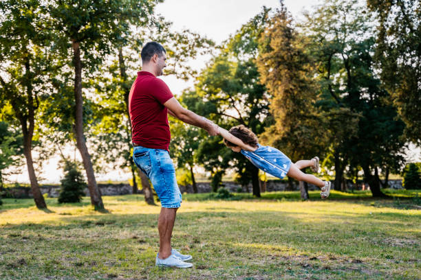 istock Father spinning daughter and playing with her 1317667689