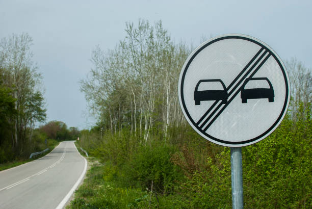 End of No overtaking road traffic sign closeup on country road
