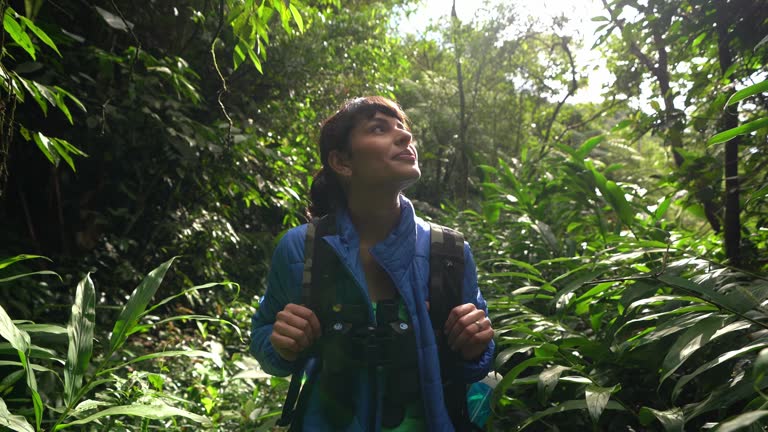 Young woman contemplating while hiking in a forest