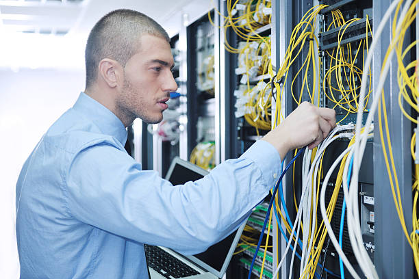 istock businessman with laptop in network server room 131766957