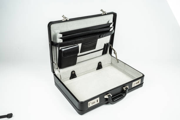 istock Open men's black leather briefcase fork, glass and plate on a white background 1317670476