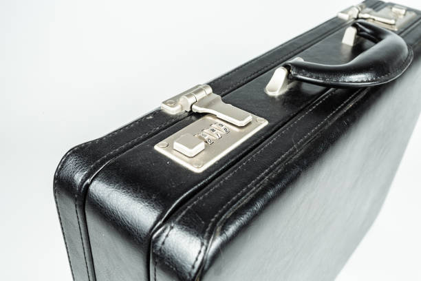 istock men's black leather briefcase fork, glass and plate on a white background 1317670494
