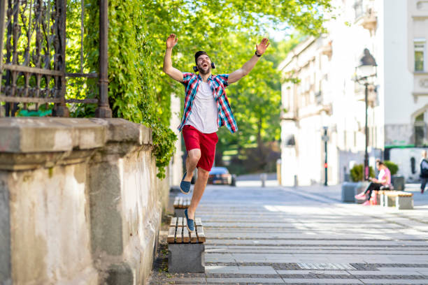 istock Modern young smiling man enjoying music outdoor 1317671817