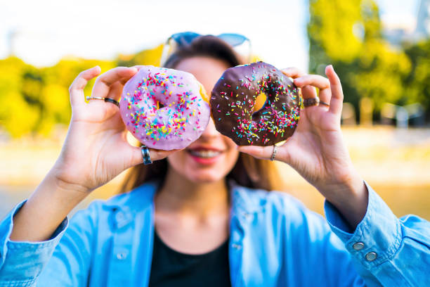 istock Woman holding donuts against eyes 1317671998