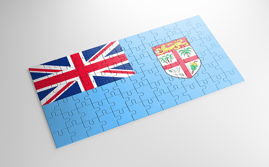 A jigsaw puzzle with a print of the flag of Fiji, pieces of the puzzle isolated on white background. Fulfillment and perfection concept. Symbol of national integrity. 3D illustration.