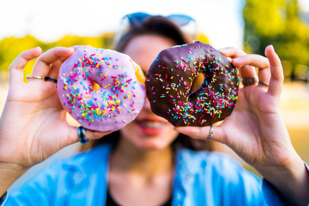 istock Woman holding donuts against eyes 1317672335