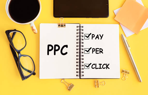 Writing PPC - abbrevation PAY PER CLICK - Concepts on notepad on office desk.