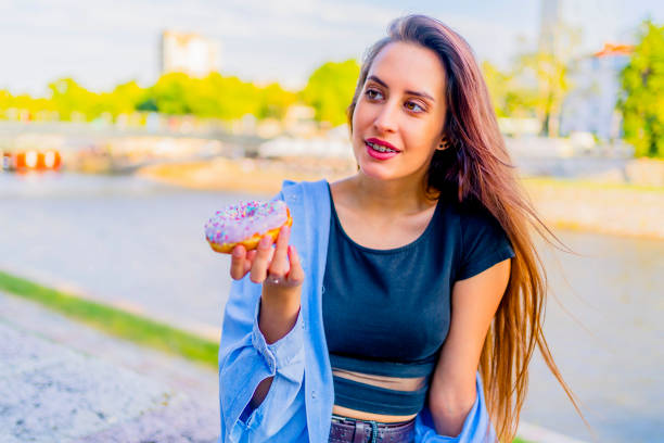 istock Woman enjoying eating donut 1317674535