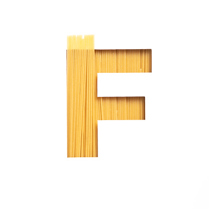 Spaghetti italian food. Letter F of English alphabet made of pasta, white cut paper. Typeface for grocery products store. High quality photo
