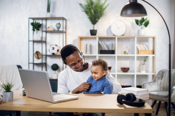 istock Afro american man using and taking care of son 1317675560