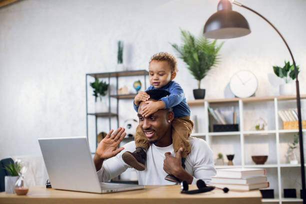 istock Afro american father with baby son working from home 1317675612