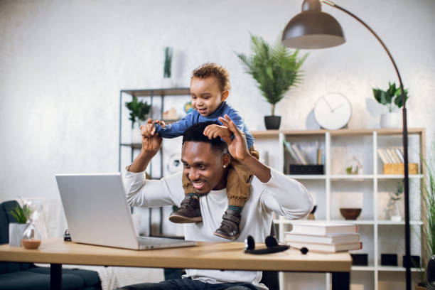 istock Afro american father with baby son working from home 1317675620