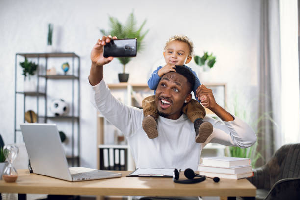 istock Father and son taking selfie on smartphone at home 1317675653