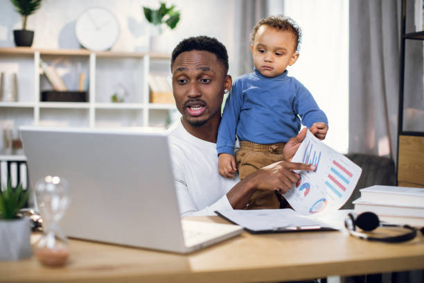 istock African businessman working from home with son on hands 1317675665