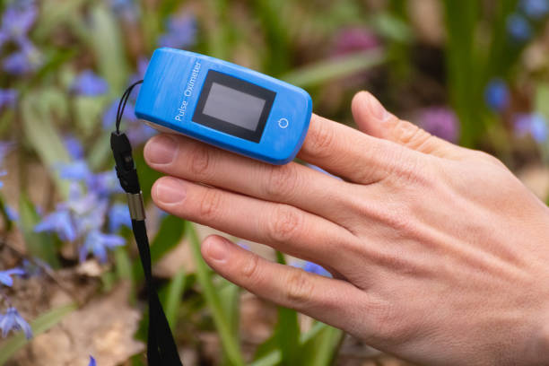istock Pulse oximeter on finger close-up in blue flowers 1317675735