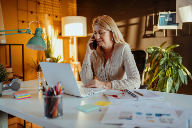 istock Mature woman doing finances at home and calling customer support 1317676849