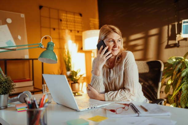 istock Mature businesswoman doing finances at home and calling customer support 1317677027