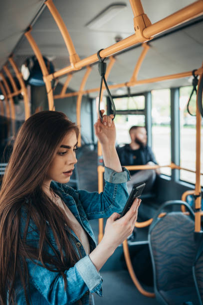 istock Young woman using a smartphone in the bus 1317677090