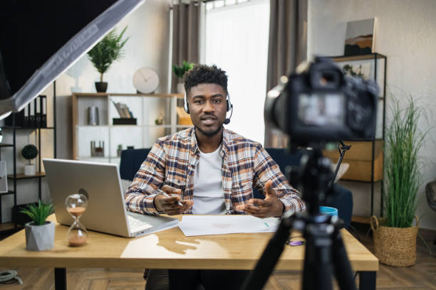 istock Afro american teacher in headset conducting online lessons 1317677221