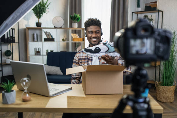 istock Blogger doing live stream while unpacking new sneakers 1317677307