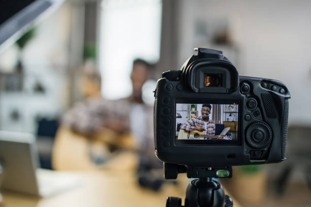 istock Afro american man recording video about playing guitar 1317677400