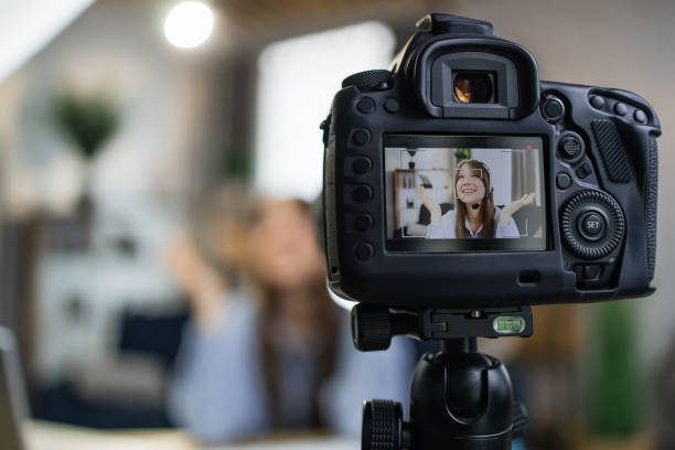 istock Woman in headset using camera for recording video 1317677980