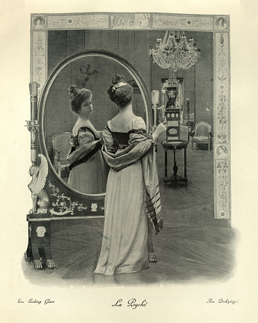 Vintage photograph of Young woman looking at her reflection in a mirror, Looking glass, Victorian photomontage19th Century