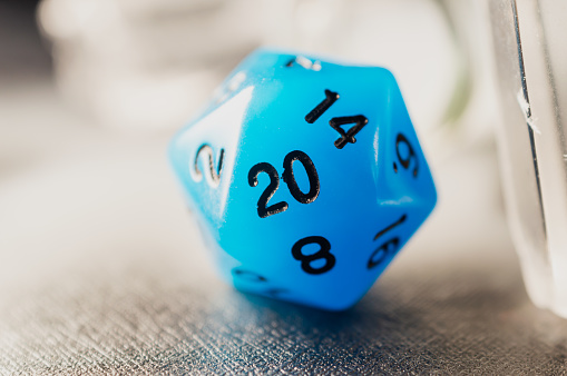 Close-up image of a blue role-playing game. Focus only on the number 20