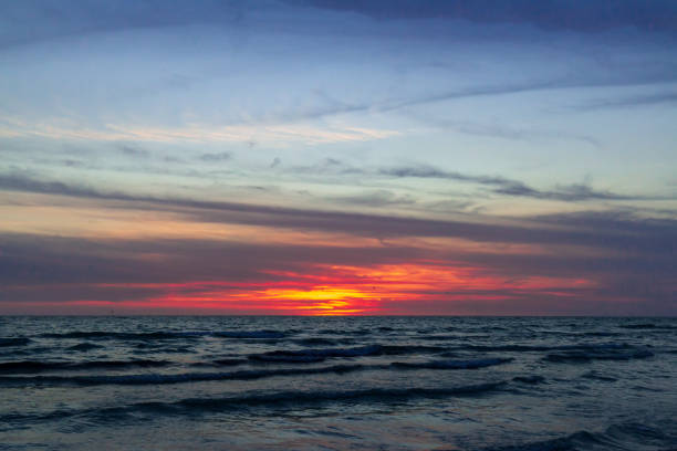 Warm Sunset On The Gulf of Mexico with Tourist Parachute Parasailing at Stickney Point at Crescent Beach Siesta Keys Florida