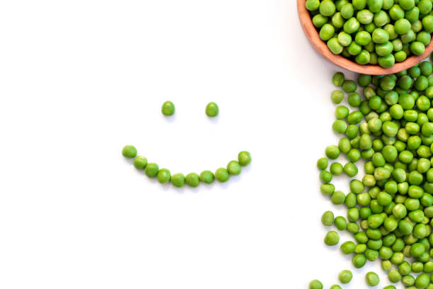 A happy little boy with a spoonful of healthy green peas.Please browse: 