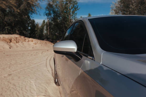 istock side view of a passenger car standing on the sand 1317685667