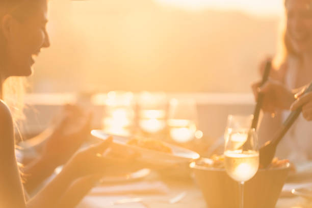 istock Defocussed image of Friends Serving salad on a table at sunset. 1317685867
