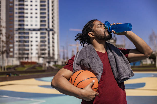 istock Sportsman drinking water and taking a break from basket 1317687050