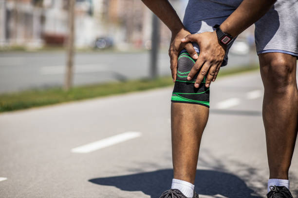 istock Young sportsman feeling knee pain while working out 1317688042