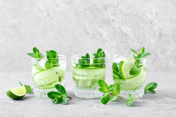 istock Mint, lime and cucumber refreshing infused detox cocktail with ice, light refreshment summer mocktail 1317689112