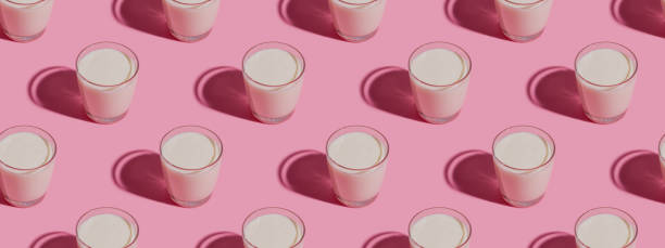 istock World Milk Day. Pattern on a  pink background. A glass of milk. Pattern. Banner 1317690066