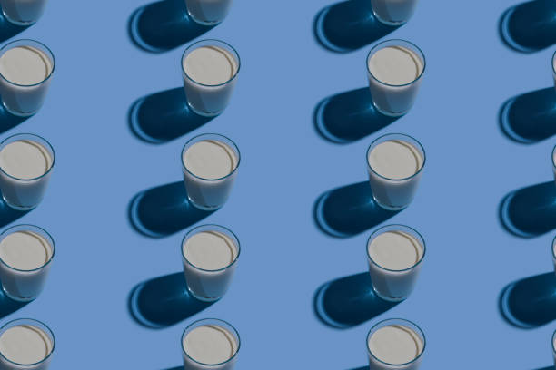 istock World Milk Day. Pattern on a blue background. A glass of milk. Pattern. 1317690124
