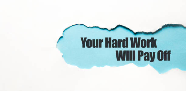 istock Your hard work will pay off appearing behind torn brown paper 1317690183