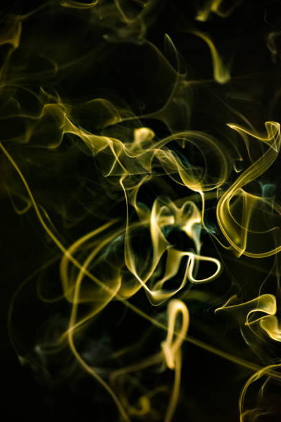 istock Golden yellow smoke in swirling pattern 1317704448