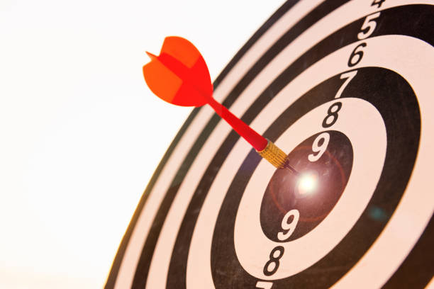 istock Dart arrow hit center on bullseye dartboard is target 1317714905