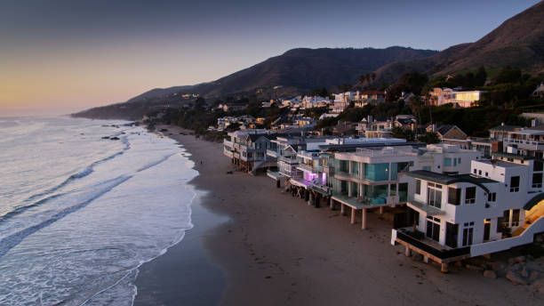 Beach Houses In Malibu at Sunset - Aerial Aerial drone still from above the coastline in Malibu, California at sunset. pacific coast stock pictures, royalty-free photos & images