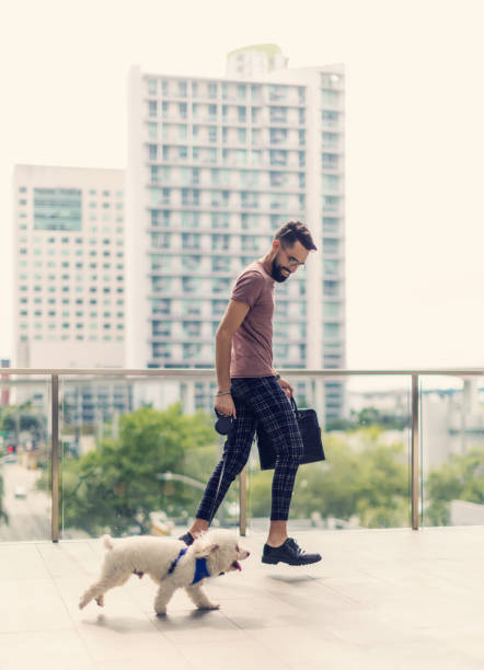 istock Hispanic man running in the city with small dog 1317722249