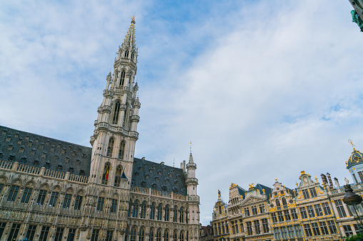 crowd tourists walking in  Grote Markt square and Belfort tower in Bruges, Belgium.