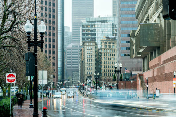 istock crowd pedestrian and traffic car with tall building raining day in downtown Boston Massachusetts, United States 1317724682