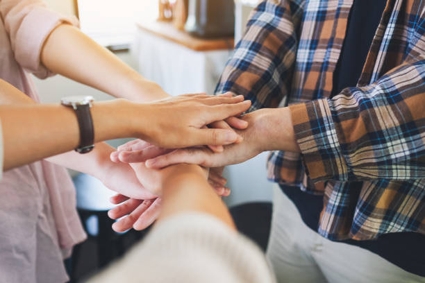 istock business team standing and joining their hands together in office 1317724997