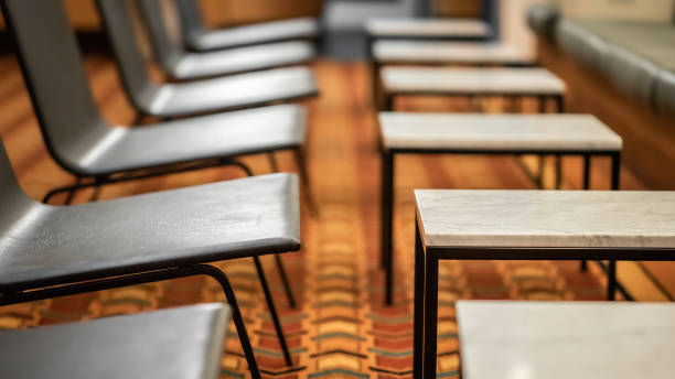 istock A row of stylish chairs and side tables on a orange pattern carpet 1317730395
